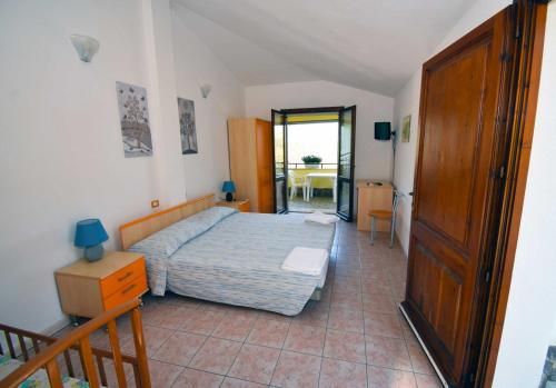 a bedroom with a bed and a table at La Corte Degli Ulivi in Cardedu