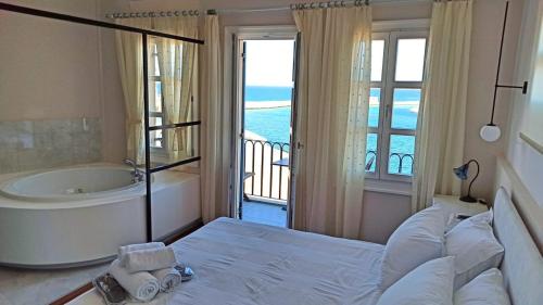 
a hotel room with two beds and a large window at Hotel Amphora in Chania Town
