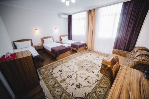 Postel nebo postele na pokoji v ubytování Sunrise Osh