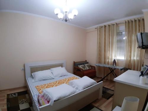 a bedroom with a bed with two pillows at JON apartment KORCE in Korçë