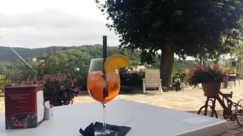 a glass of orange juice sitting on a table at Locanda del Borgo in Prunetto