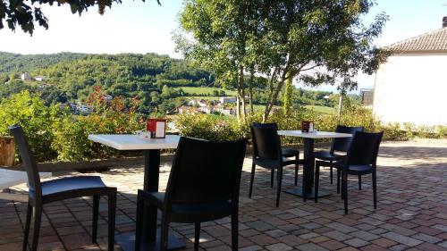 a group of tables and chairs sitting on a patio at Locanda del Borgo in Prunetto