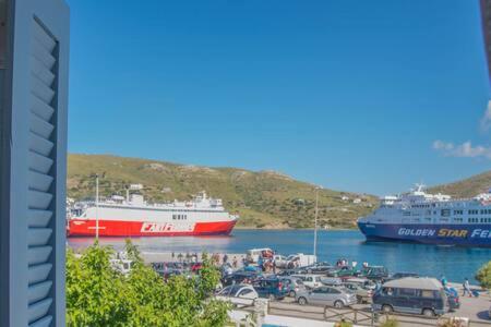a red and white boat is docked in a harbor at Portogavrio Apartment in Gavrion
