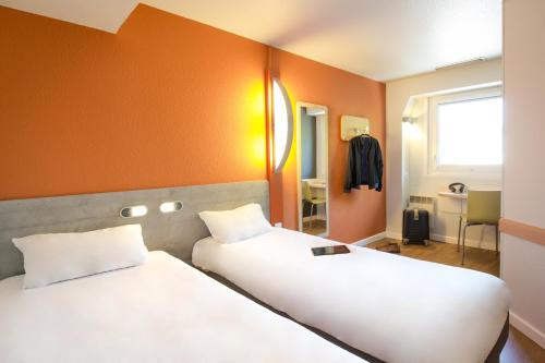 Postel nebo postele na pokoji v ubytování ibis budget Vienne Sud