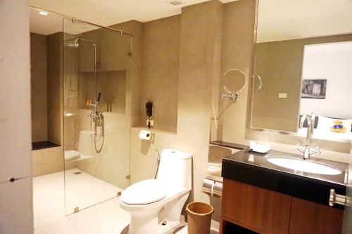a bathroom with a toilet and a sink and a shower at S33 Compact Sukhumvit Hotel in Bangkok