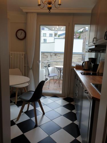 a kitchen with a table and a chair in a kitchen at Sophienstrasse Appartement in Baden-Baden