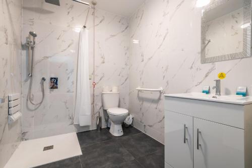 
a bathroom with a toilet a sink and a shower at Peterborough by Verve in Peterborough
