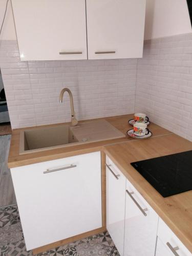 a kitchen with white cabinets and a sink at Pokój u Katarzyny in Węgorzewo