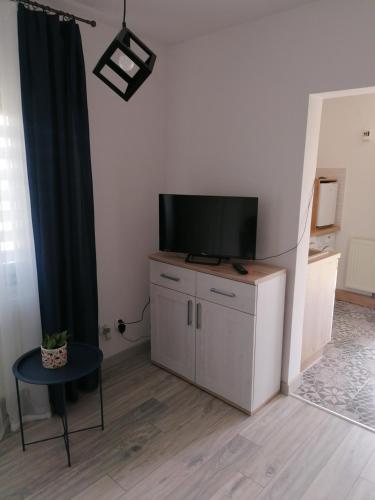 a living room with a flat screen tv on a cabinet at Pokój u Katarzyny in Węgorzewo