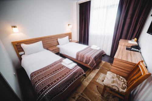 Postel nebo postele na pokoji v ubytování Sunrise Osh