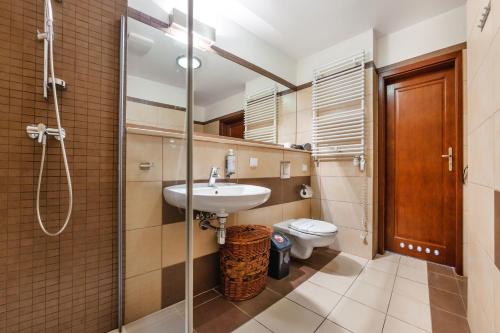 a bathroom with a sink and a toilet at Olympic Park I, Sun & Snow in Kołobrzeg