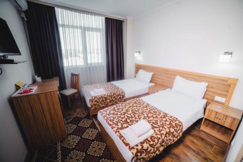 Postel nebo postele na pokoji v ubytování Sunrise Osh