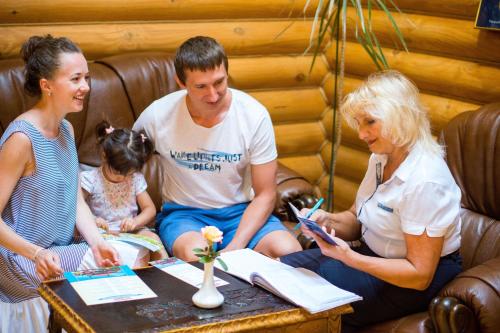 a group of people sitting around a table at Комплекс відпочинку Пампушка & Подушка in Odesa