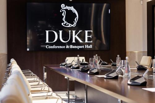 a long table with a sign for a duke conference and banquet hall at Ribas Duke Boutique Hotel in Odesa