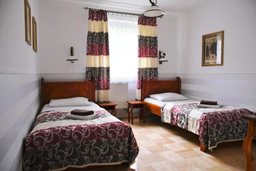 a bedroom with two beds and a window at Śnieżka in Krosno