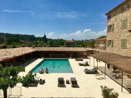 a large swimming pool in front of a building at Domaine De La Chapelle in Lorgues