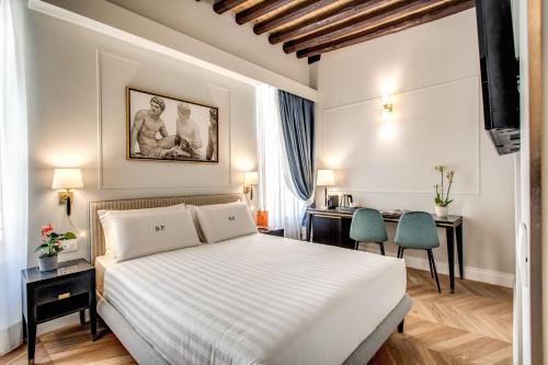 a bedroom with a white bed and two chairs at Babuino Palace&Suites in Rome