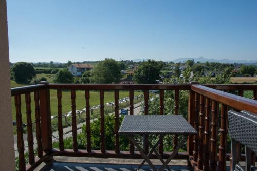 a table and chairs on a balcony with a view at Posada de Suesa in Suesa