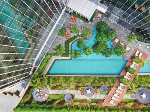 an overhead view of a pool in front of a building at Swissôtel Jakarta PIK Avenue in Jakarta