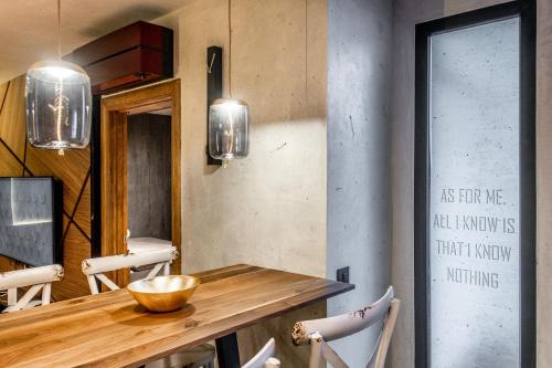 a dining room with a wooden table and chairs at Bella Roe Premium Apartments in Belgrade