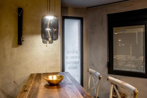 a dining room with a wooden table with a bowl on it at Bella Roe Premium Apartments in Belgrade