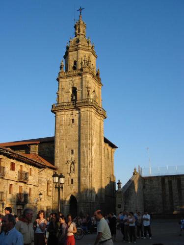a group of people standing in front of a clock tower at Casa Otxandi in Ochandiano