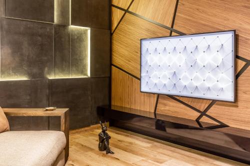 a tv on a wall in a room at Bella Roe Premium Apartments in Belgrade