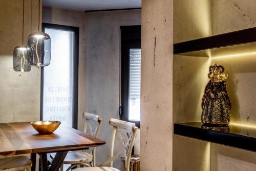 a dining room with a table and a vase on a shelf at Bella Roe Premium Apartments in Belgrade