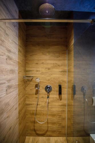 a bathroom with a shower with a glass wall at Casa Hrisicos in Constanţa