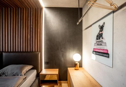 a bedroom with a bed and a table and a lamp at Bella Roe Premium Apartments in Belgrade