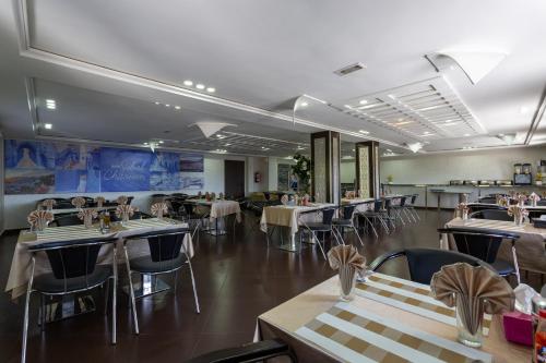 a dining room with tables and chairs and tablesktop at Hotel Jibal Chaouen in Chefchaouene