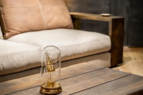a coffee table with a glass object on top of it at Bella Roe Premium Apartments in Belgrade