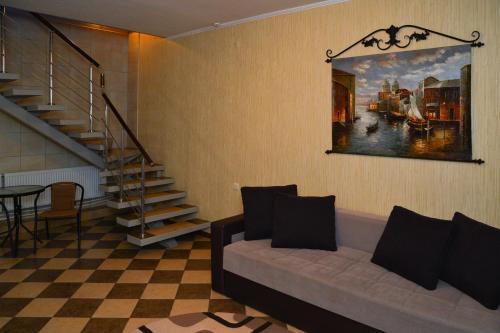 a living room with a couch and a painting on the wall at Holiday Village Katrin in Nova Kakhovka