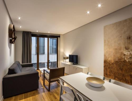 a living room filled with furniture and a large window at Mon Suites Catedral in Valencia