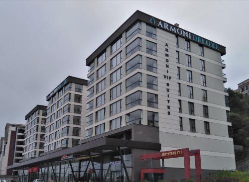 a large white building with a sign on it at Armoni Deluxe Suites Trabzon in Trabzon