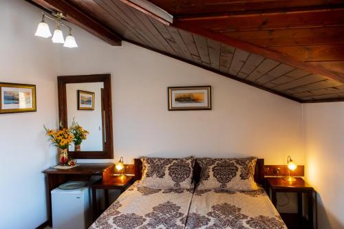 a bedroom with a bed with two night stands and two lamps at Grancharova Guest House in Bansko