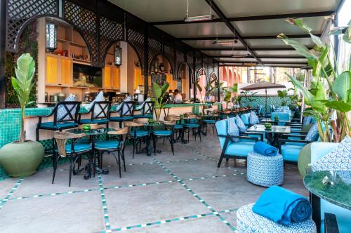 a restaurant with blue chairs and tables and a bar at El Andalous Lounge & Spa Hotel in Marrakesh