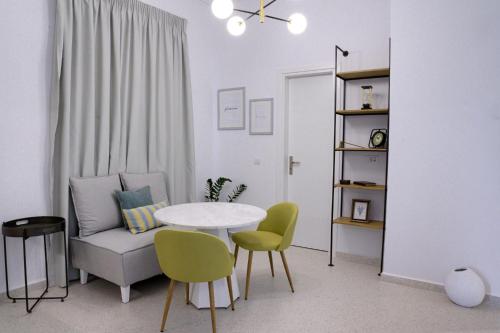 a living room with a table and a chair and a couch at The Well View in Preveza