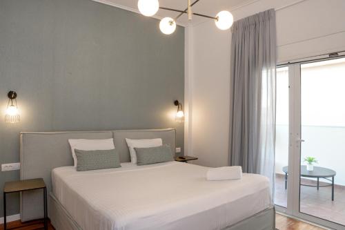 a bedroom with a large bed with white sheets and pillows at The Well View in Preveza