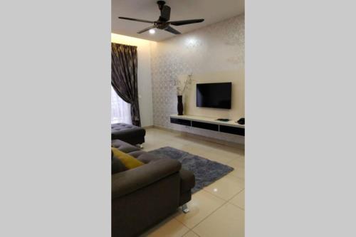 a living room with a couch and a tv at Selayang 18 Lovely 2R2B, Netflx and Wi-Fi provided in Batu Caves
