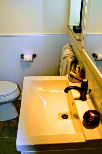 a bathroom with a sink and a toilet at Villa Venezia in Fort Lauderdale