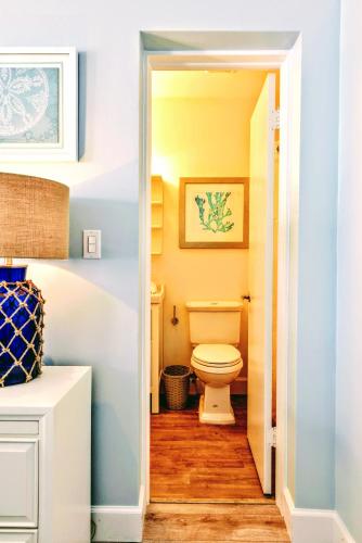 a bathroom with a white toilet in a hallway at Villa Venezia in Fort Lauderdale