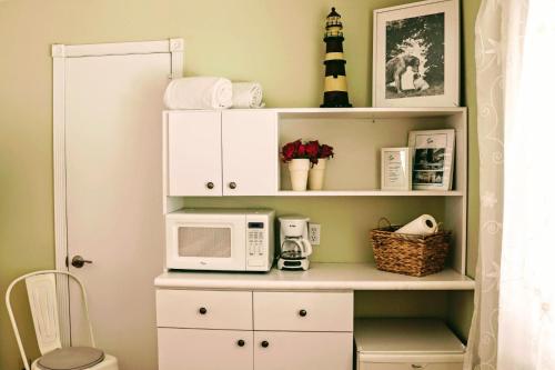 a kitchen with a microwave on a white shelf at Villa Venezia in Fort Lauderdale