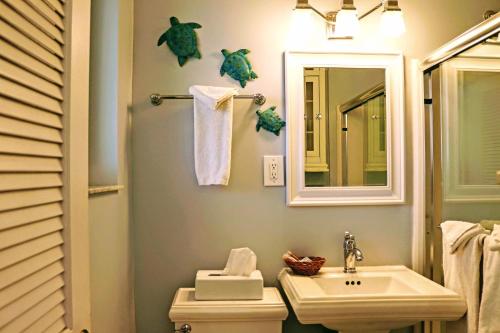 a bathroom with a sink and a toilet and a mirror at Villa Venezia in Fort Lauderdale