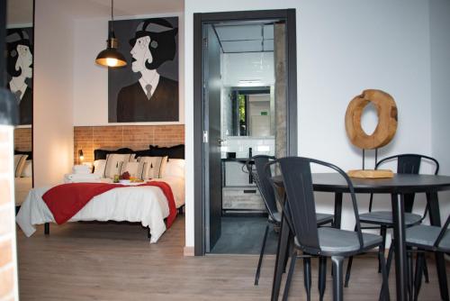 a bedroom with a bed and a table and chairs at Soraya's Place - Chopín 2 in Valencia