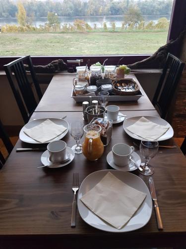a wooden table with plates of food on it at Rheinblick Hattenheim Boutique Art Gästehaus in Hattenheim