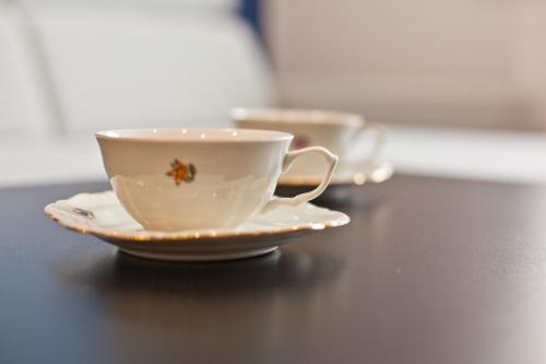 two cups and saucers sitting on a table at ABA Centrum in Krynica Zdrój