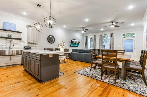 a kitchen and living room with a table and chairs at 5BR w Pool - Great for Families - Near Everything in New Orleans