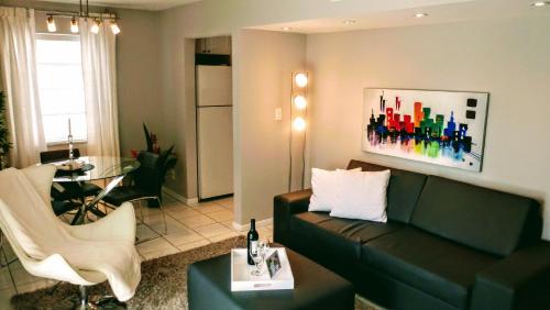 a living room with a couch and a table at Villa Venezia in Fort Lauderdale