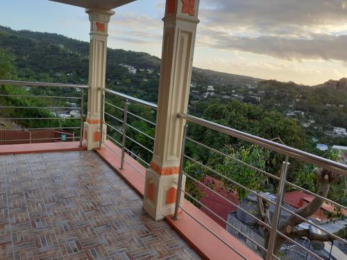 a balcony with a view of a city at Résidence Véronia in Rodrigues Island